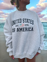 Effortless Pearl Grey Crewneck Sweatshirt with Embroidered Flag Detail
