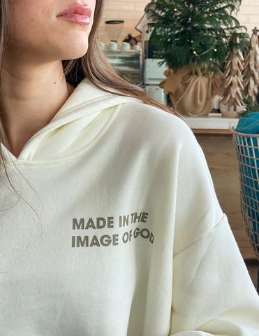 Cozy Cream Hoodie with Inspirational Bible Verse Genesis 1:27